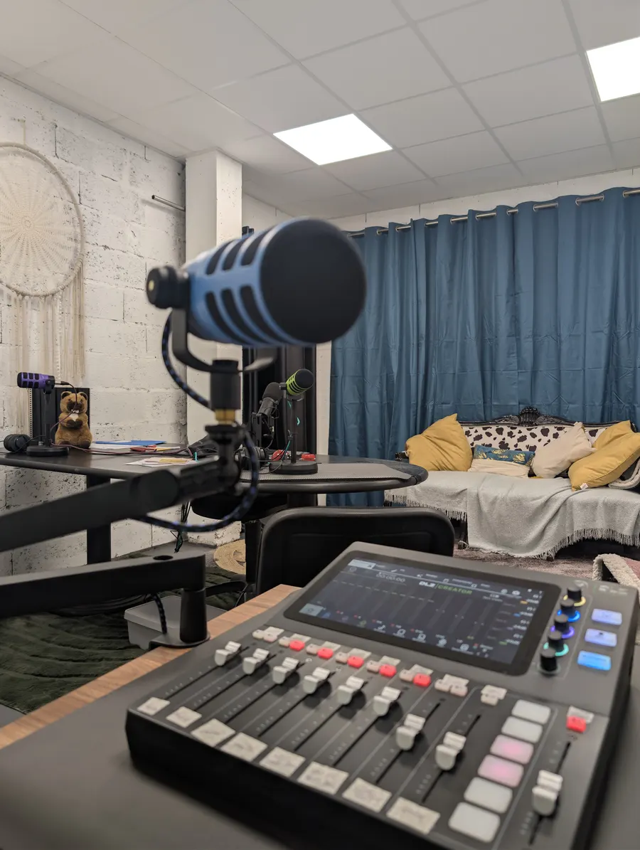 Studio podcast : micro et table de mixage devant l’espace d’enregistrement